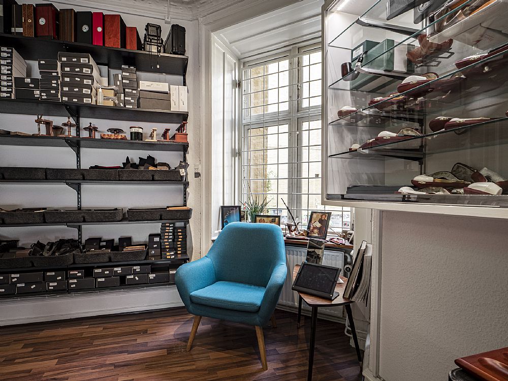 The lounge corner of the shop with the reading chair and pipe shelves